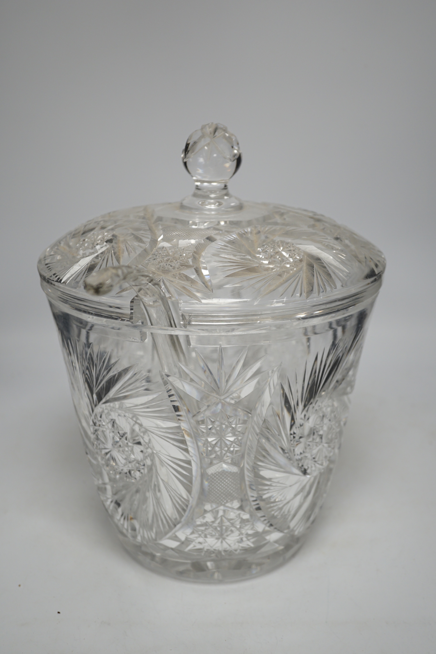 A large and heavy slice-cut lead crystal punch jar and cover, together with a ladle, 33cm